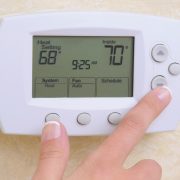 adjusting thermostat in your home
