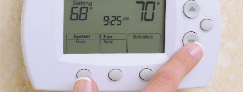 adjusting thermostat in your home